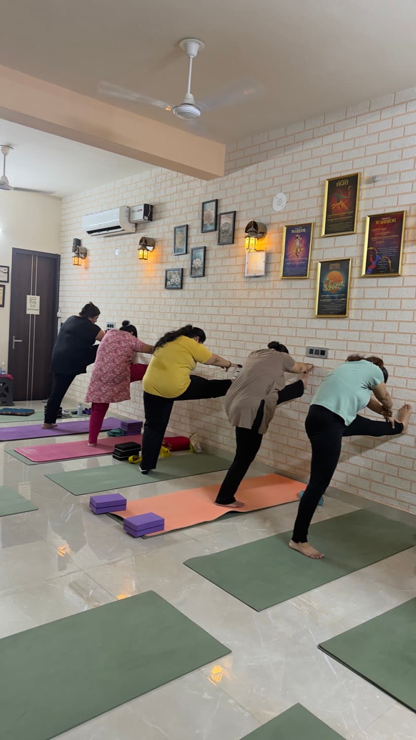 A class holding a standing balance pose on mats