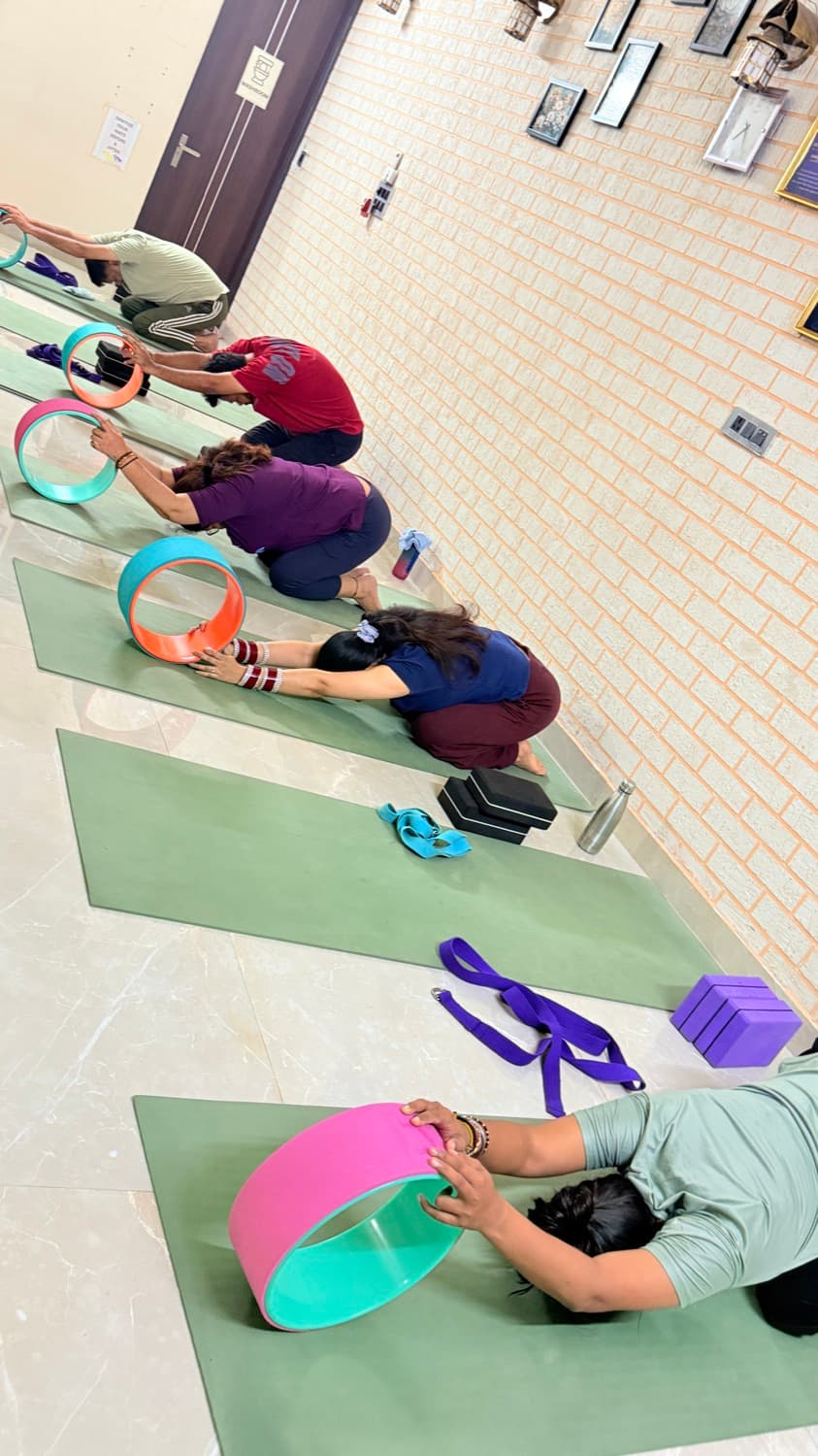 Students practising wheel yoga