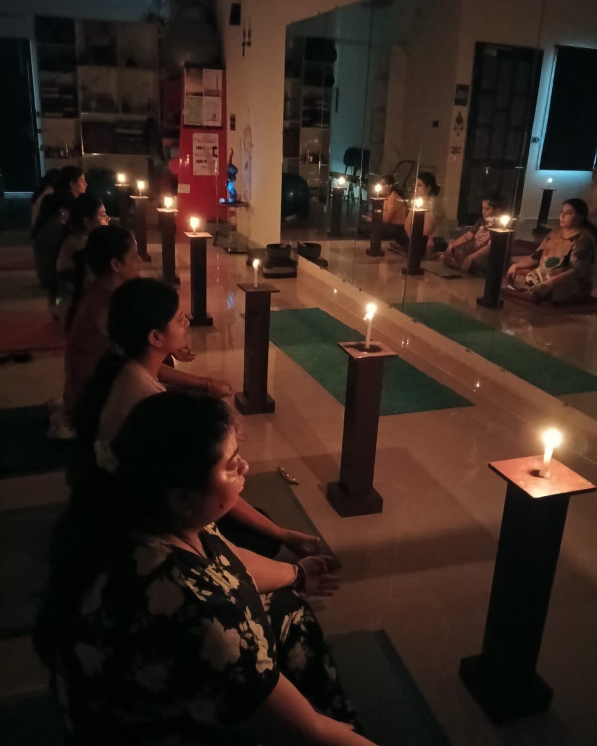 A candlelit group healing session in the studio